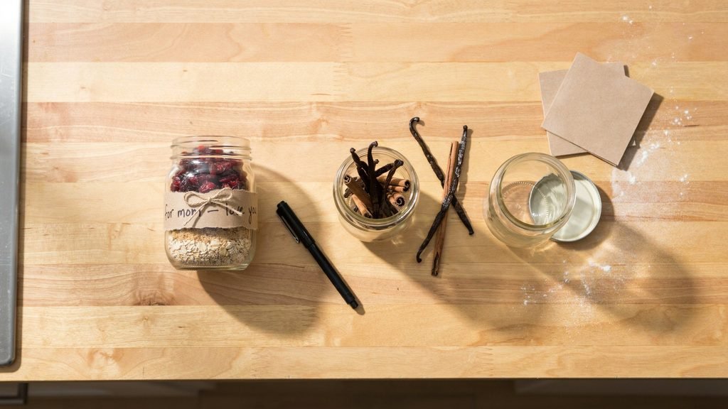 hree small jars on a kitchen counter, one already filled and labeled 