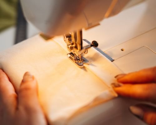 Beginner sewing a straight stitch with back light