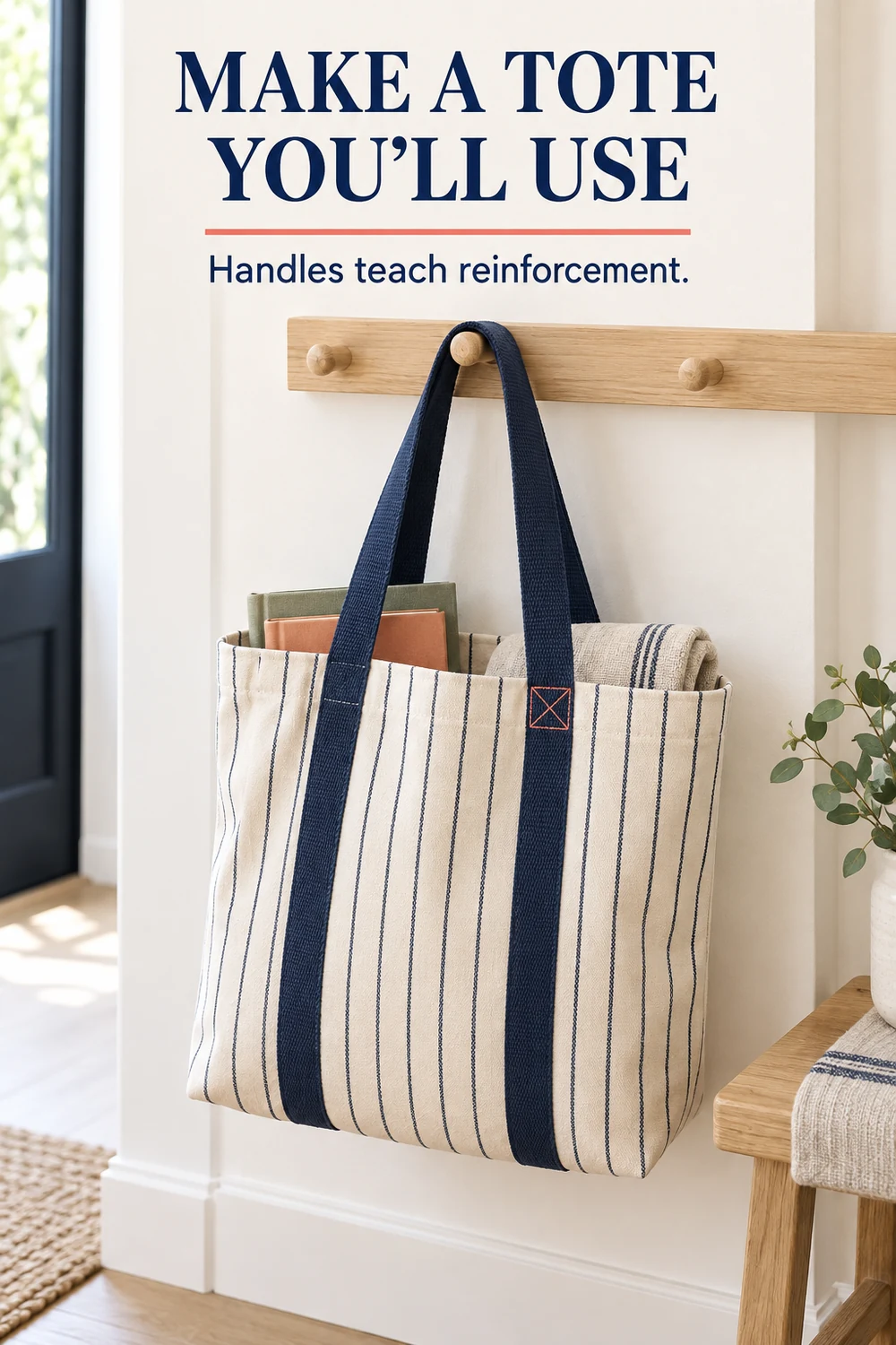 Handmade cream canvas tote with narrow navy stripes hanging from an oak peg with books inside.