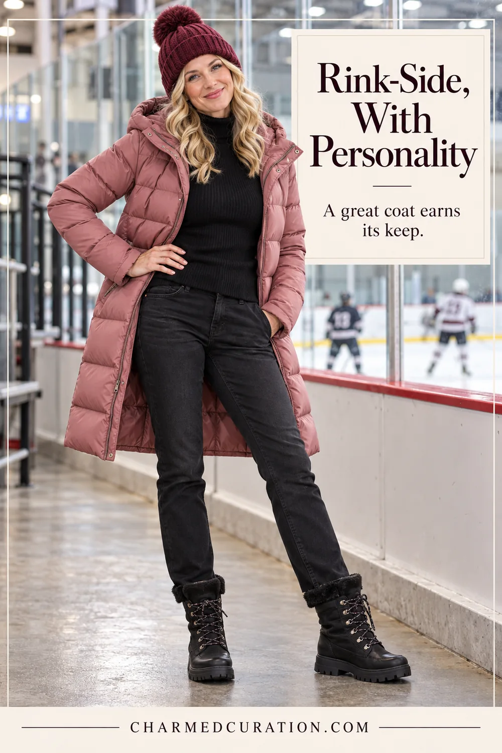 Woman beside an ice hockey rink wearing a rose puffer, burgundy beanie, black jeans and black winter boots.