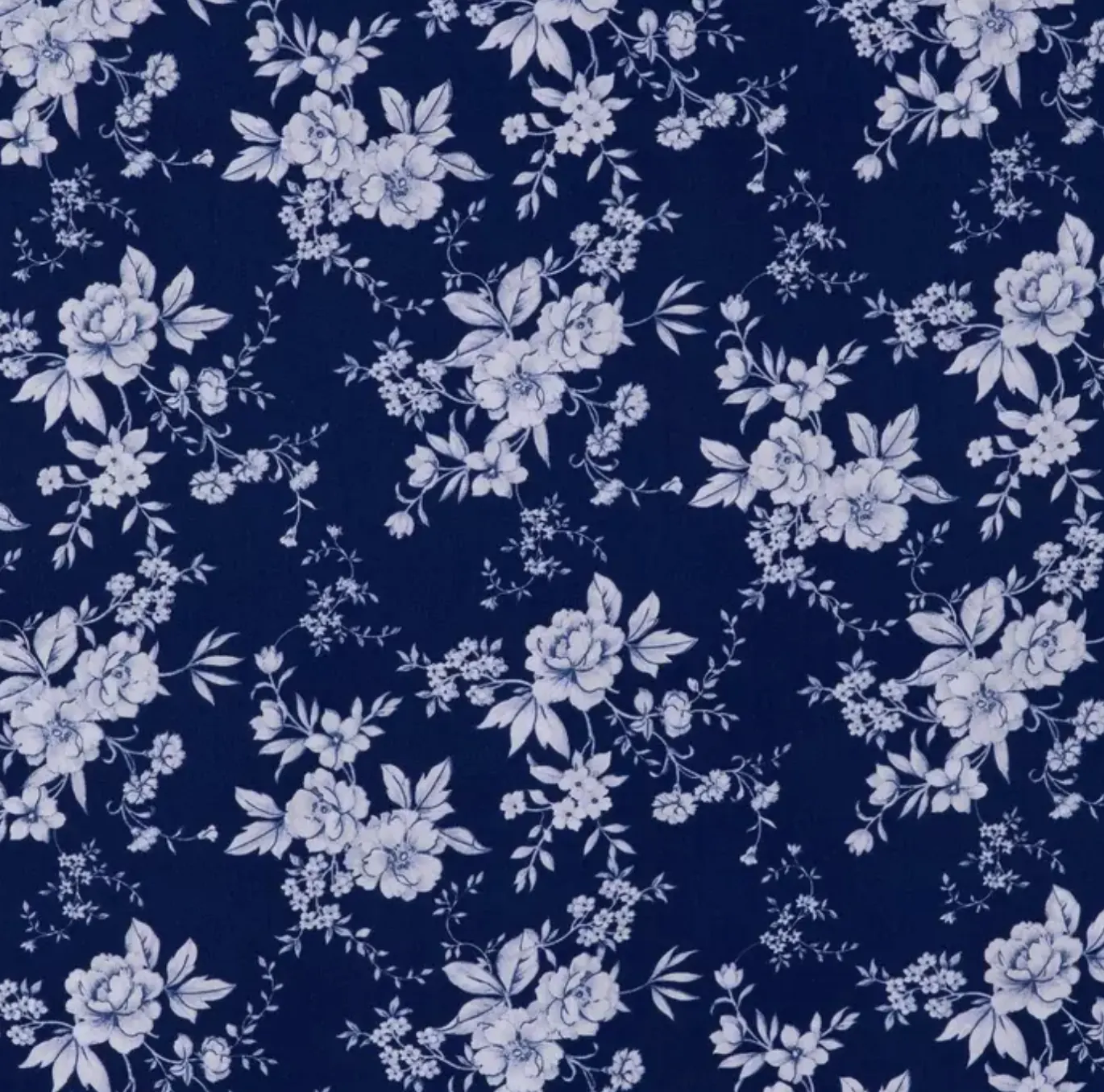 Deep navy fabric print with pale blue-white roses, leaves, and small floral vines.