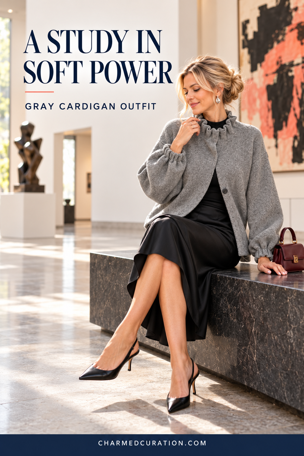 Gray ruffle-neck cardigan styled with a black satin skirt for an evening outfit.